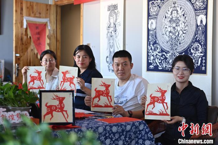 6月6日，在甘肅敦煌青年夜校課程中，青年學(xué)員展示學(xué)習(xí)敦煌非遺剪紙的成果。李亞龍 攝　　